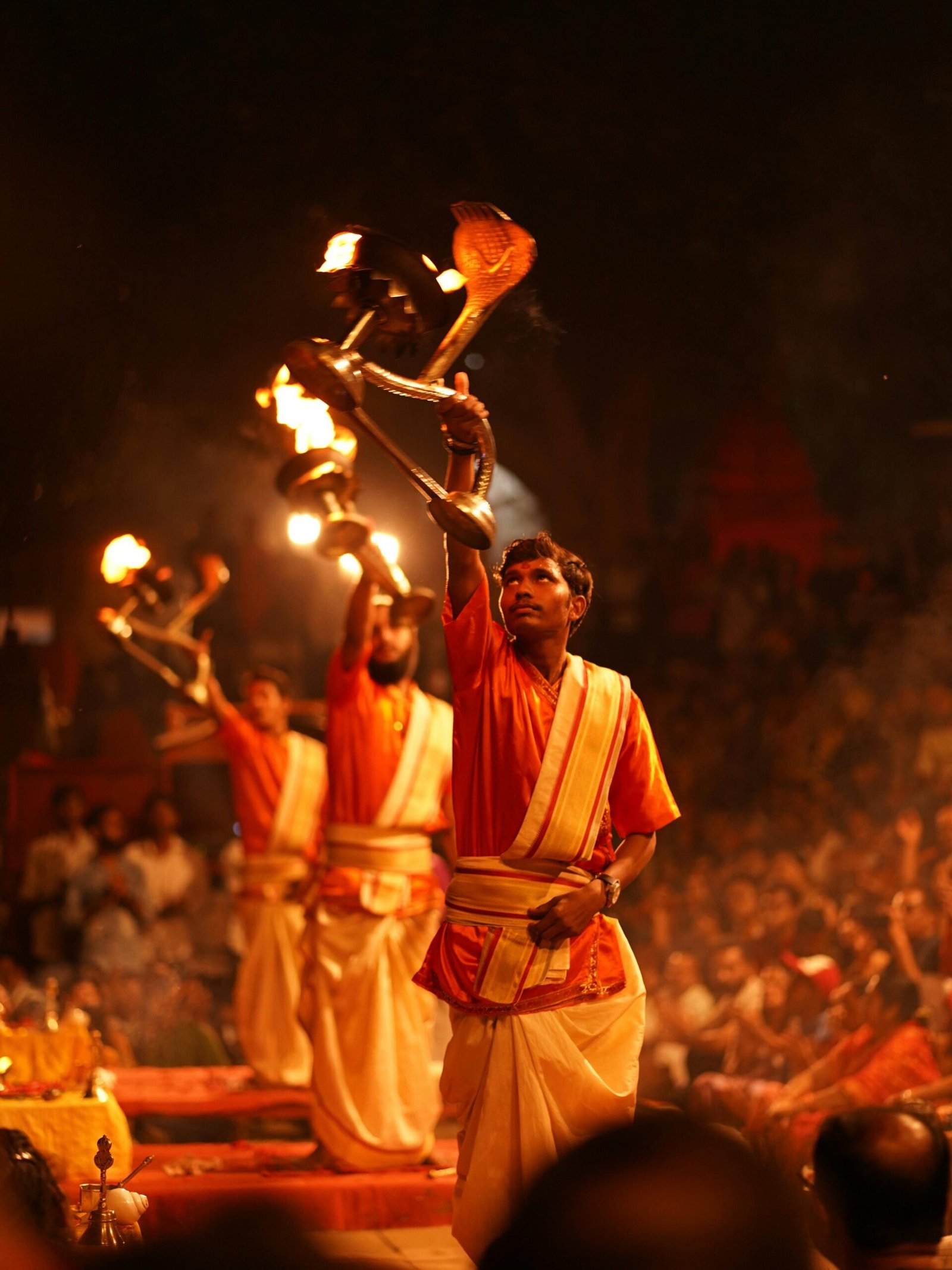 Priests perform the sacred Ganga Aarti ritual on the ghats of Varanasi, India.